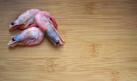Fresh shrimp on a wooden cutting boardの写真素材