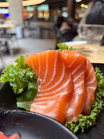 Salmon sashimi on black plate, japanese food in restaurant.の写真素材
