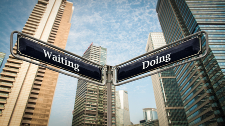 Street Sign Doing versus Waitingの写真素材