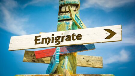 Street Sign the Direction Way to Emigrateの写真素材