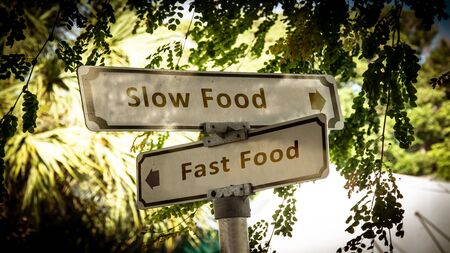 Street Sign the Direction Way to Slow versus Fast Foodの写真素材
