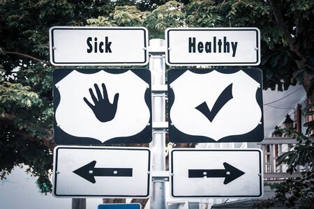 Street Sign the Direction Way to Healthy versus Sickの写真素材