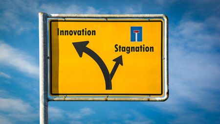 Street Sign the Direction Way to Innovation versus Stagnationの写真素材
