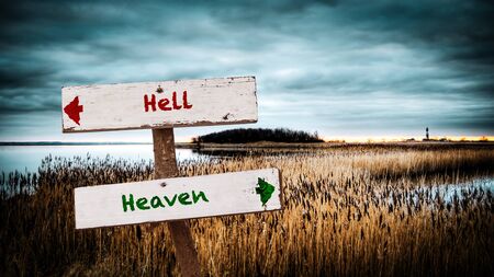 Street Sign the Direction Way to Heaven versus Hellの写真素材
