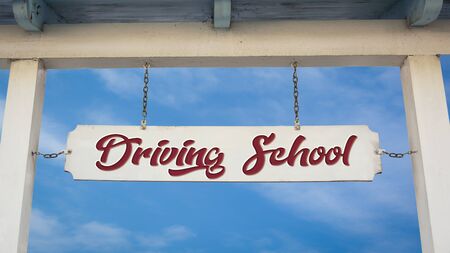 Street Sign the Direction Way to DRIVING SCHOOLの写真素材