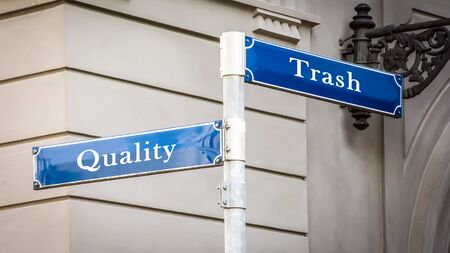 Street Sign the Direction Way to Quality versus Trashの写真素材