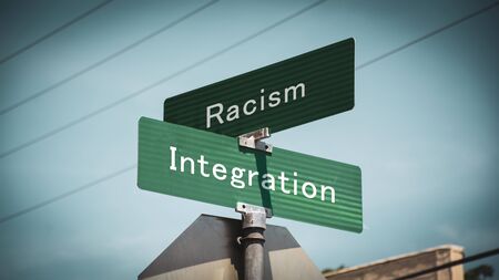 Street Sign the Direction Way to Integration versus Racismの写真素材