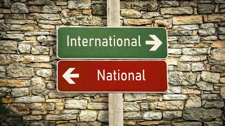 Street Sign the DIrection Way to International versus Nationalの写真素材