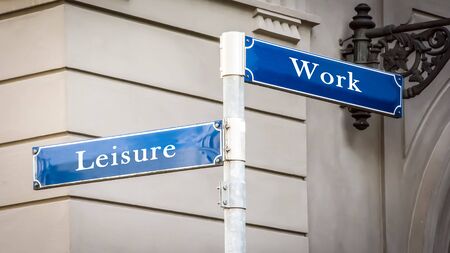 Street Sign the Direction Way to Leisure versus Workの写真素材