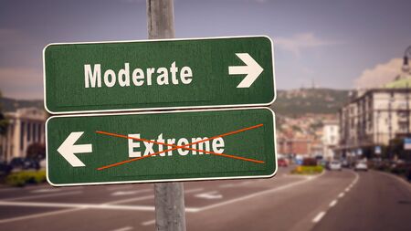 Street Sign the Direction Way to Moderate versus Extremeの写真素材