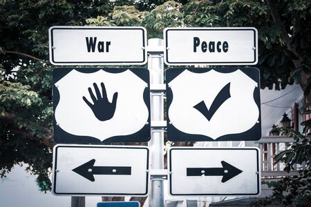 Street Sign the Direction Way to Peace versus Warの写真素材