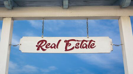 Street Sign the Direction Way to Real Estateの写真素材