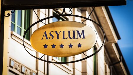 Street Sign the Direction Way to Asylumの写真素材