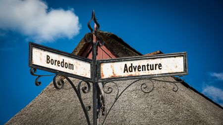 Street Sign the Direction Way to Adventure versus Boredomの写真素材