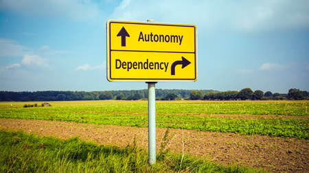 Street Sign the Direction Way to Autonomy versus Dependencyの写真素材
