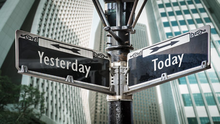 Wall Sign the Direction Way to Today versus Yesterdayの写真素材