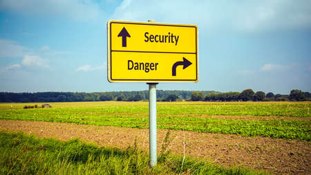 Street Sign the Direction Way to Security versus Dangerの写真素材