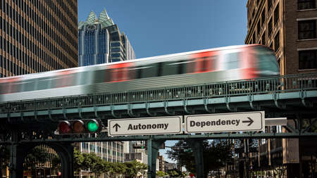 Street Sign the Direction Way to Autonomy versus Dependencyの写真素材