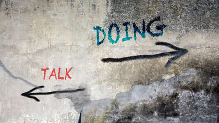 Street Sign the Direction Way to Doing versus Talkの写真素材