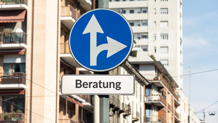 the picture shows a sign post and a sign pointing in the direction of advice in germanの写真素材
