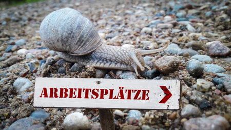 Image shows a sign post and a sign pointing towards jobs in German.の写真素材