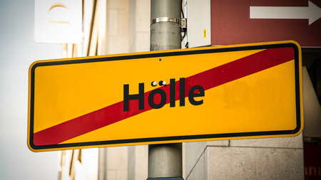 An image with a signpost pointing in two different directions in German. One direction points to today, the other points to yesterday.の写真素材