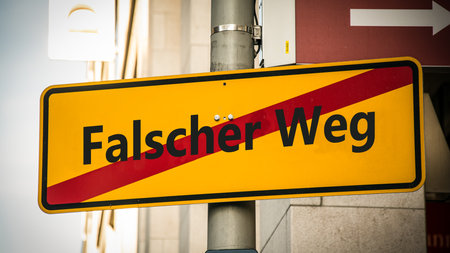 An image with a signpost pointing in two different directions in German.の写真素材