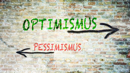 An image with a signpost pointing in two different directions. One direction points to optimism, the other points to pessimism.の写真素材