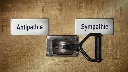 An image with a signpost pointing in two different directions in German. One direction points to sympathy, the other points to antipathy.の写真素材