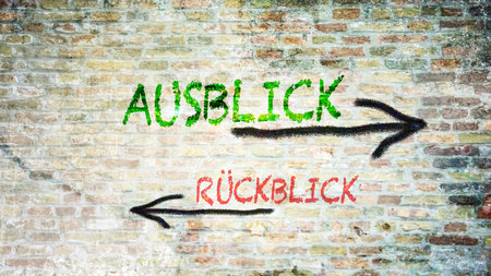 An image with a signpost pointing in two different directions in German. One direction points to outlook, the other points to backsightの写真素材