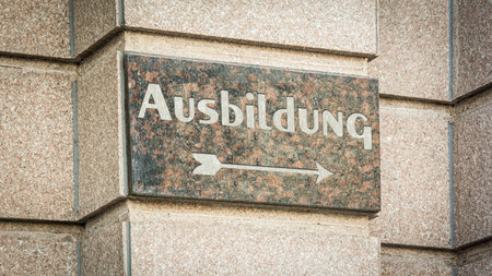 Image shows a signpost and a sign in the direction of an education in German.の写真素材