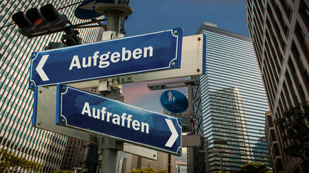 An image with a signpost pointing in two different directions in German. One direction points to picking up, the other pointing to giving up.の写真素材