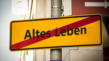 An image with a signpost pointing in two different directions in German. One direction points to New Life, the other points to Old Life.の写真素材