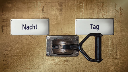 An image with a signpost pointing in two different directions in German. One direction shows day, the other shows night.の写真素材