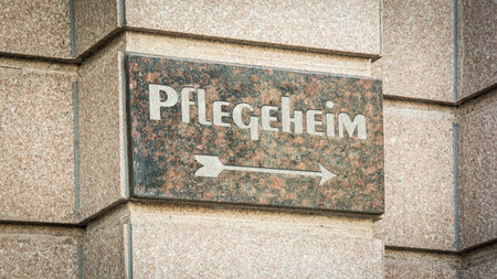 An image with a signpost in German pointing in the direction of the nursing home.の写真素材