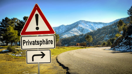 An image with a signpost in German pointing in the direction of privacy.の写真素材