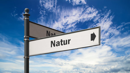 An image with a signpost in German pointing in the direction of nature.の写真素材