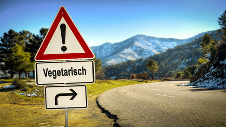 An image with a signpost in German pointing in the direction of Vegetarian.の写真素材