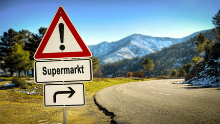 An image with a signpost in German pointing towards the supermarket.の写真素材