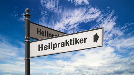 The picture shows a signpost and a sign that points in the direction of Naturopath in German.の写真素材