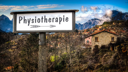 An image with a signpost in German pointing in the direction of physical therapy.の写真素材