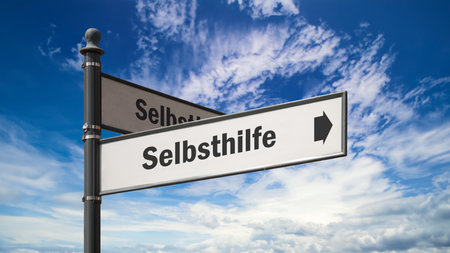 An image with a signpost in German pointing in the direction of self-help.の写真素材