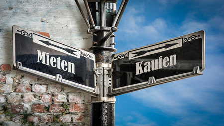 An image with a signpost pointing in two different directions in German. One direction points to buy, the other points to rent.の写真素材