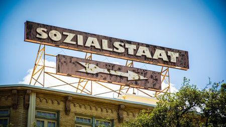 An image with a signpost in German pointing in the direction of the welfare state.の写真素材