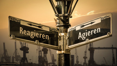An image with a signpost pointing in two different directions in German. One direction points to...