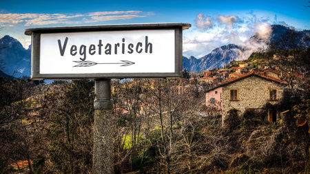 An image with a signpost in German pointing in the direction of Vegetarian.の写真素材