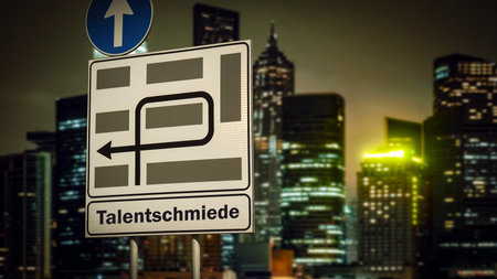 An image with a signpost in German pointing in the direction of the talent factory.の写真素材