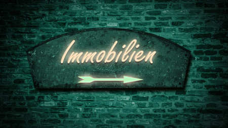 The picture shows a sign post and a sign that points to real estate in German.の写真素材