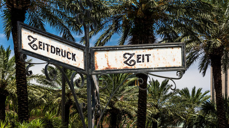 An image with a signpost pointing in two different directions in German. One direction points by...