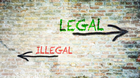 An image with a signpost pointing in two different directions in German. One direction points Legal, the other points Illegal.の写真素材